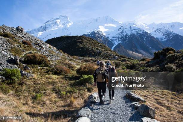 Hikers walk in the Hooker Valley track at Aoraki / Mount Cook National Park in the South Island, New Zealand, on August 05, 2020. The lookout point...