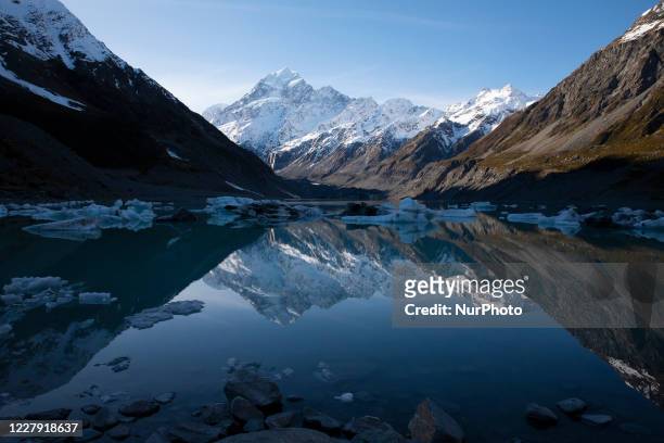 Reflection of the highest mountain in New Zealand Mount Cook also known as Aoraki is seen in the Hooker Lake at Aoraki / Mount Cook National Park in...