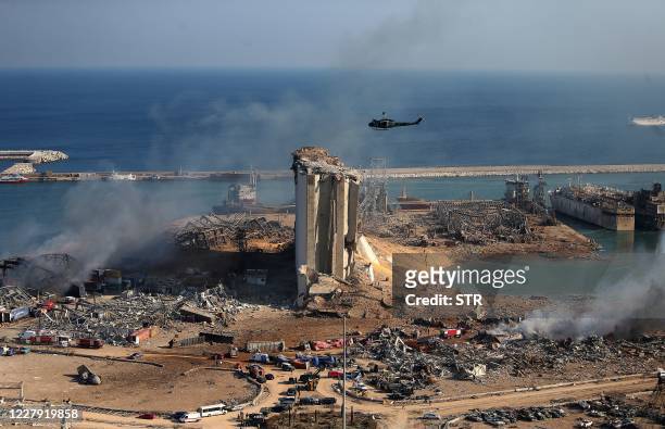 General view shows the damaged grain silos of Beirut's harbour and its surroundings on August 5 one day after a powerful twin explosion tore through...