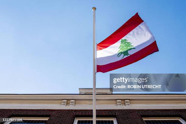 The Lebanon flag hangs at half-mast at the Embassy of Lebanon in The Hague, The Netherlands on August 5, 2020 after a powerful explosion tore through...