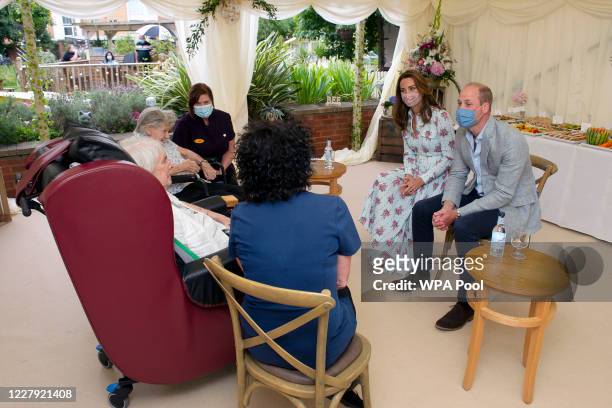 Prince William, Duke of Cambridge and Catherine, Duchess of Cambridge listen to Joan Drew Smith as she tells the Royal couple what she thought of...