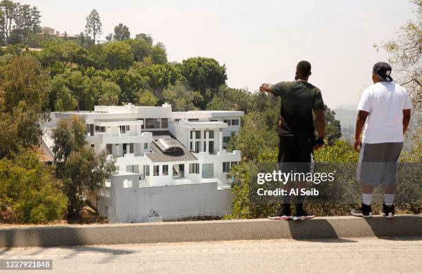 People who attended the party last night watch from Mulholland Drive as LAPD Police investigate the location of the huge home on 13200 Mulholland...