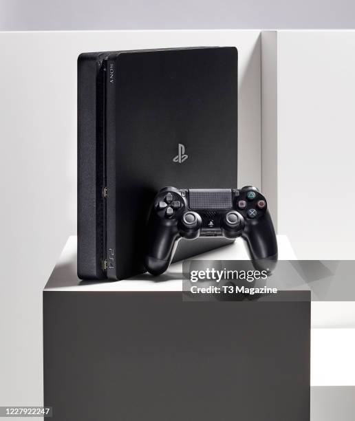 Sony PlayStation 4 video game console and DualShock 4 wireless controller, taken on February 14, 2020.