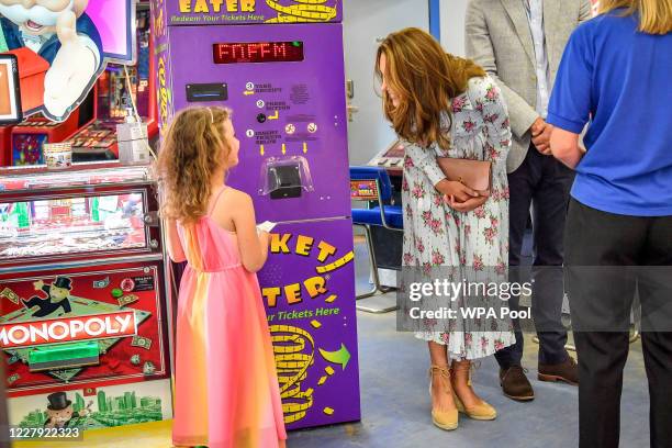 Catherine, Duchess of Cambridge talks to Erin Phillips at Island Leisure Amusement Arcade, where Gavin and Stacey was filmed, during their visit to...