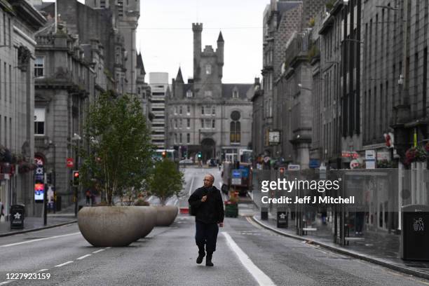 Pedestrian walks on an empty street on August 5, 2020 in Aberdeen, Scotland. Scotland's First Minister Nicola Sturgeon acted swiftly and put Aberdeen...