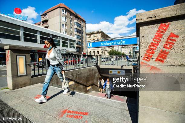 Graffitti reading 'Decolonize the city' is seen at the entrance of Mohrenstrasse train station in Berlin on July 21, 2020. Anti racism activists are...