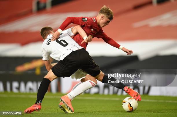 S Austrian defender Philipp Wiesinger vies with Manchester United's English defender Brandon Williams during the UEFA Europa League last 16 second...