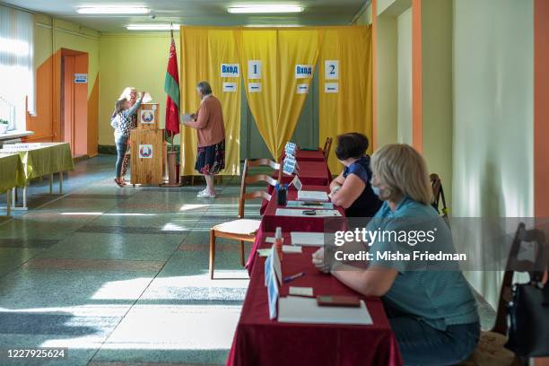 Woman casts her early voting ballot at a polling place in Minsk, Belarus. Belorussians head to the polls on Aug. 9 to decide whether President...