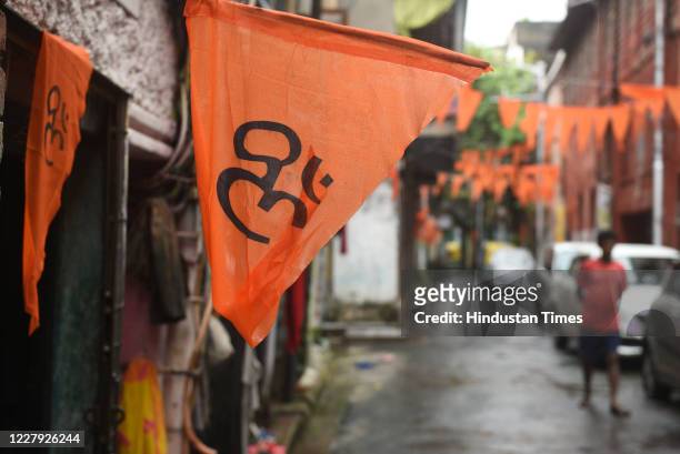 Saffron flag hangs outside a house marking the foundation laying ceremony of the Ram Temple in Ayodhya, during twice in - weekly complete lock down...