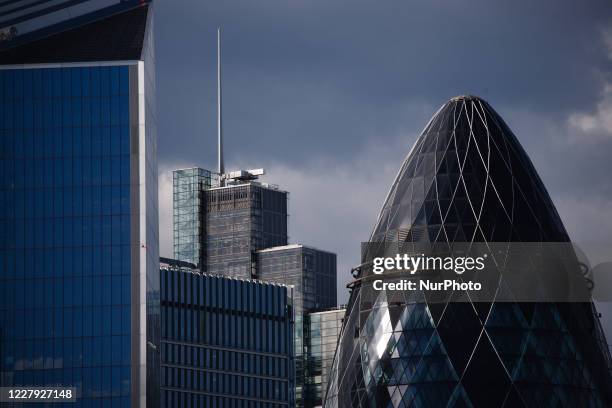 The commercial towers of 110 Bishopsgate and 30 St Mary Axe stand in the City of London financial district in London, England, on August 5, 2020....