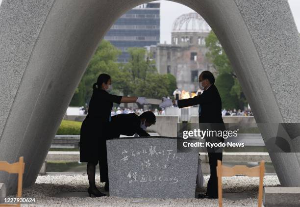Hiroshima Mayor Kazumi Matsui dedicates a list of people who died from the 1945 U.S. Atomic bombing at the cenotaph at Peace Memorial Park on Aug. 6...