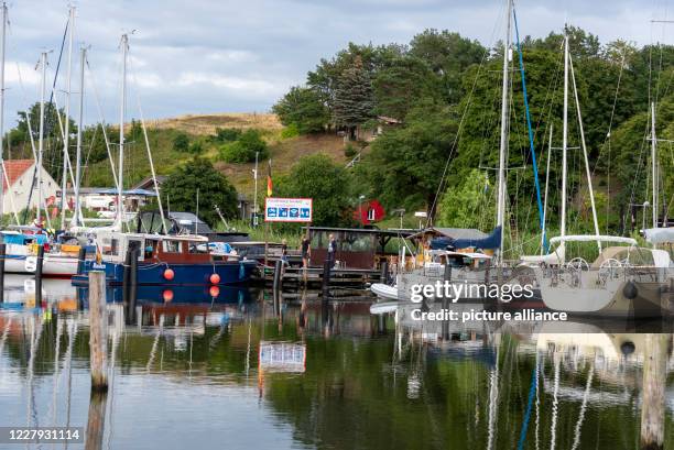 August 2020, Mecklenburg-Western Pomerania, Seedorf: The motor boat Ruden, sailing boats and yachts are moored at the trout jetty. Seedorf was once...