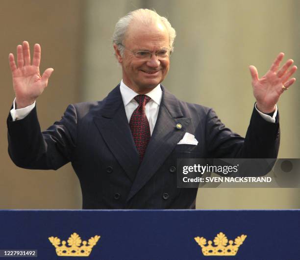 King Carl XVI Gustaf of Sweden waves to well-wishers from the Stockholm Palace as he celebrates his 60th birthday, 30 April 2006.