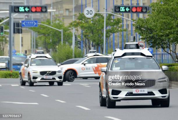 Self-driving taxis of Didi Chuxing run in Shanghai on July 1, 2020. The Chinese ride-hailing giant has started an autonomous taxi operation on public...