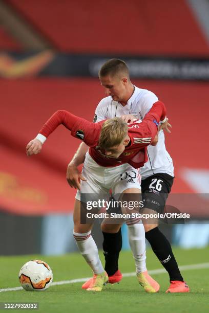 Brandon Williams of Man Utd holds off Reinhold Ranftl of LASK during the UEFA Europa League round of 16 second leg match between Manchester United...