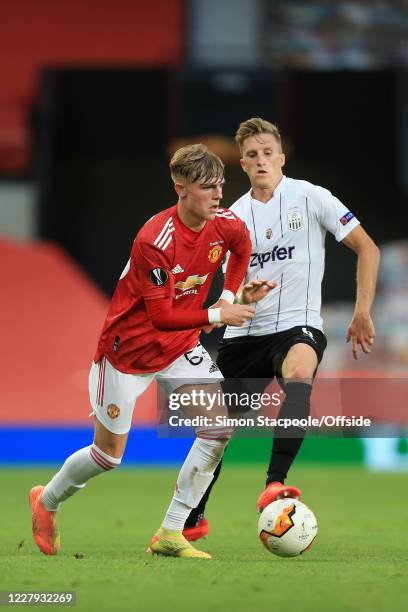Brandon Williams of Man Utd battles with Philipp Wiesinger of LASK during the UEFA Europa League round of 16 second leg match between Manchester...