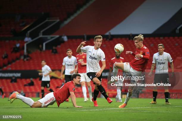 Brandon Williams of Man Utd clears from Marko Raguz of LASK during the UEFA Europa League round of 16 second leg match between Manchester United and...