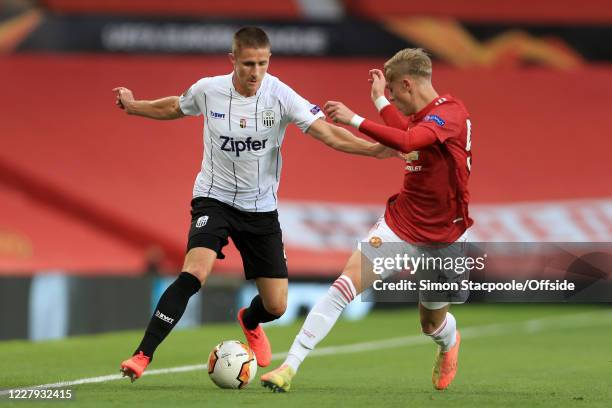 Reinhold Ranftl of LASK battles with Brandon Williams of Man Utd during the UEFA Europa League round of 16 second leg match between Manchester United...