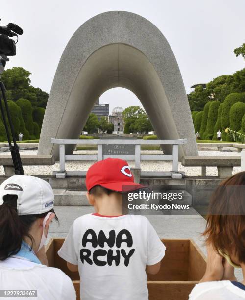 Children pray at the cenotaph at the Peace Memorial Park in Hiroshima on Aug. 6 the 75th anniversary of the U.S. Atomic bombing of the western Japan...