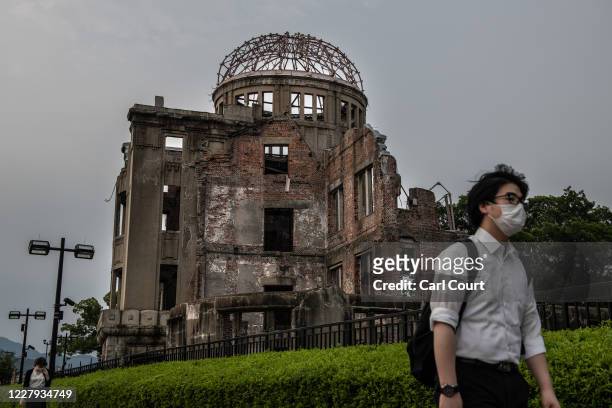 People walk past the Atomic Bomb Dome on the 75th anniversary of the Hiroshima atomic bombing, on August 6, 2020 in Hiroshima, Japan. In a ceremony...
