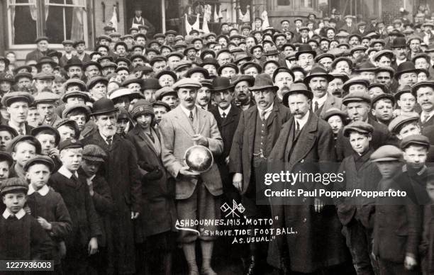 Vintage postcard featuring a crowd of people in Ashbourne, Derbyshire, during World War One commemorating the ancient Royal Shrovetide Football match...