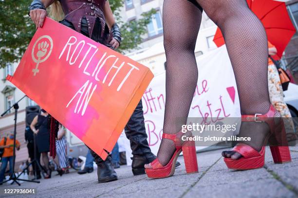 August 2020, Baden-Wuerttemberg, Stuttgart: A participant holds a sign saying "Red light on" during a demonstration on the ban of sex workers during...