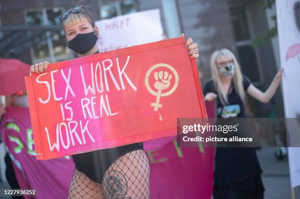 August 2020, Baden-Wuerttemberg, Stuttgart: One participant holds a sign in her hand during a demonstration on the prohibition of sex workers from...