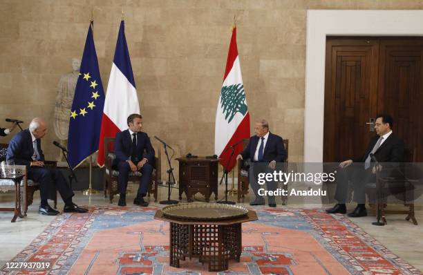 French President Emmanuel Macron meets with Lebanese President Michel Aoun and Lebanese Prime Minister Hassan Diab after a fire at a warehouse with...
