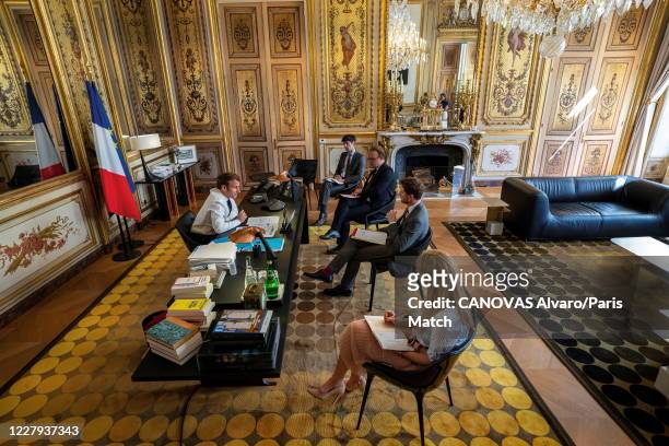 President Emmanuel Macron of France is photographed for Paris Match at his office during a conference call with Danish Prime Minister Mette...