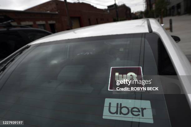 Rideshare drivers demonstrate against rideshare companies Uber and Lyft during a car caravan protest on August 6, 2020 in Los Angeles. - The drivers,...