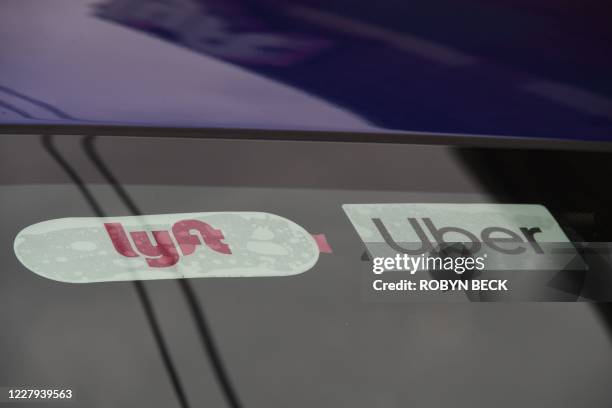 Rideshare drivers demonstrate against rideshare companies Uber and Lyft during a car caravan protest on August 6, 2020 in Los Angeles. - The drivers,...