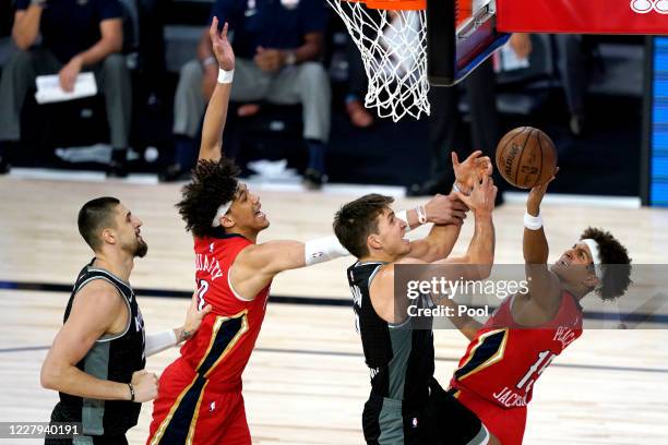 Bogdan Bogdanovic of the Sacramento Kings, center right, competes for an offensive rebound against New Orleans Pelicans' Frank Jackson, right, and...