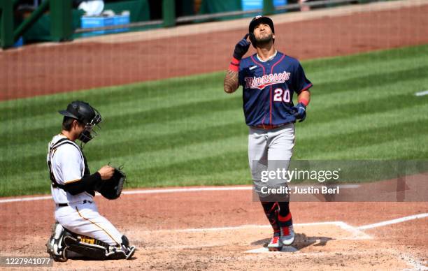 Eddie Rosario of the Minnesota Twins points to the sky as he crosses home plate after hitting a home run in the fifth inning during the game against...