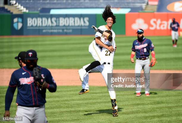 Kevin Newman of the Pittsburgh Pirates celebrates with Cole Tucker after hitting a walk-off two run single to give the Pirates a 6-5 win over the...