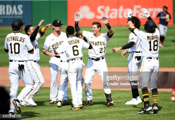 Kevin Newman of the Pittsburgh Pirates celebrates with teammates after hitting a walk-off two run single to give the Pirates a 6-5 win over the...