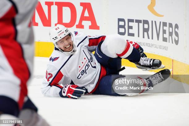 Evgeny Kuznetsov of the Washington Capitals grimaces as he grabs his leg after falling to the ice in the first period of a Round Robin game against...