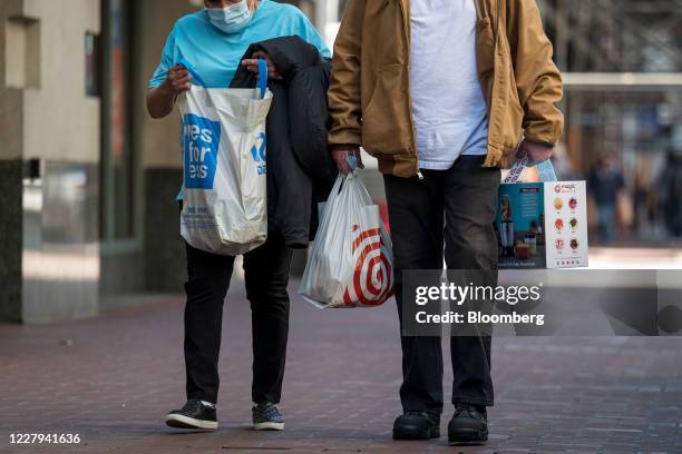 Shoppers carry Ross Stores Inc. And Target Corp. Shopping bags in San Francisco, California, U.S., on Thursday, Aug. 6, 2020. U.S. Consumer sentiment...