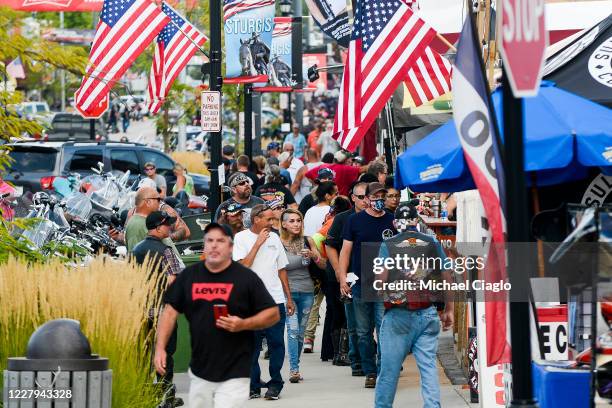 People walk along Main Street a day before the start of the Sturgis Motorcycle Rally on August 6, 2020 in Sturgis, South Dakota. While the rally...