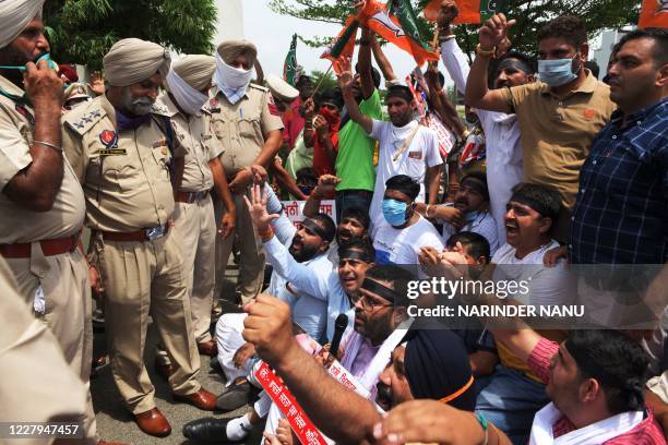 Punjab Police personnel try to stop workers of the Bharatiya Janata Yuva Morcha, the youth wing of the Bharatiya Janata Party , marching towards the...