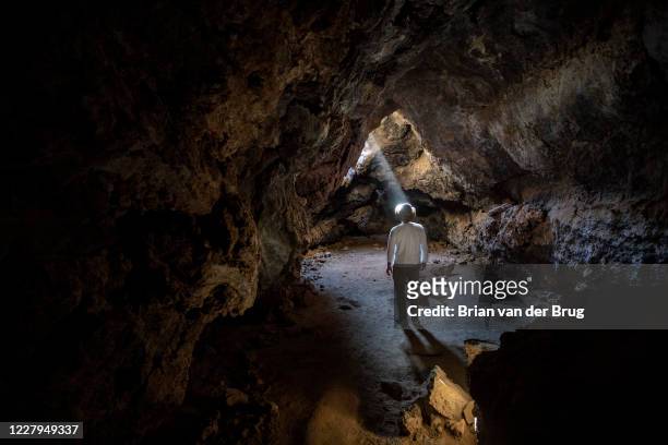 Shaft of light illuminates the Lava Tube, formed long ago by molten lava in the Mojave National Preserve along the historic Mojave Road on Wednesday,...