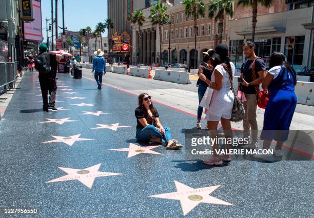 Tourists take pictures on the Walk of Fame on Hollywood Blvd, August 7 2020, inHollywood, California.