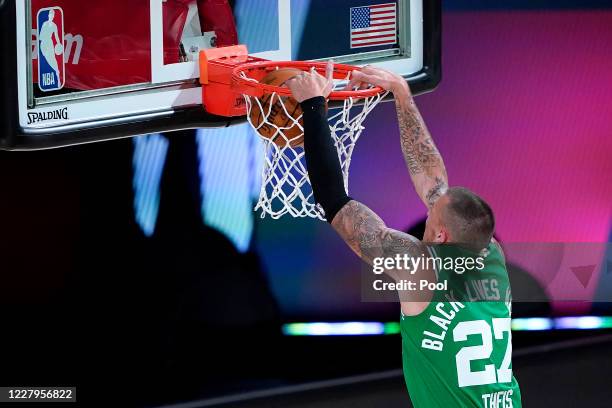 Daniel Theis of the Boston Celtics drops a dunk on the Toronto Raptors during the first half of an NBA basketball game at the ESPN Wide World Of...