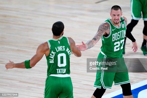 Jayson Tatum of the Boston Celtics celebrates his three-pointer with Daniel Theis of the Boston Celtics during the second half of an NBA basketball...