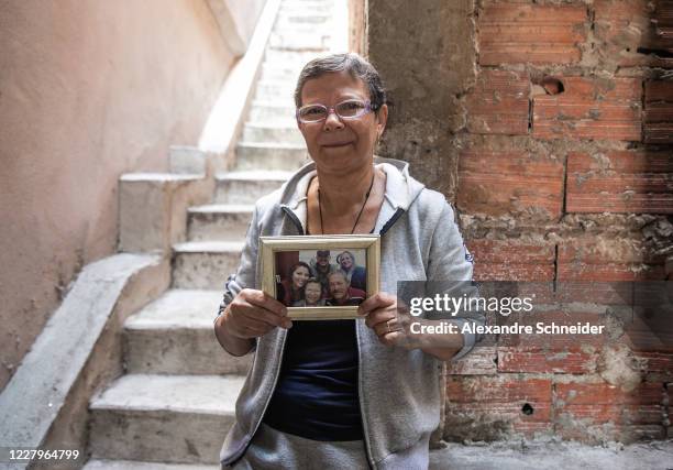 Maria Dilma Marques dos Santos holds a portrait of her husband Silvio Rodrigues da Silva Pinto a victim of the coronavirus in Vila Brasilandia on...