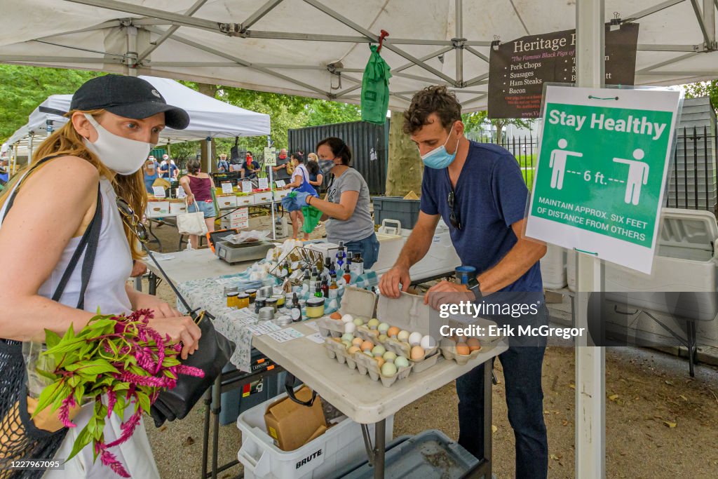 A sign ecouraging social distancing while shopping seen at...
