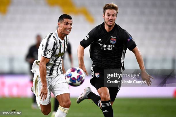 Cristiano Ronaldo of Juventus FC is challenged by Joachim Andersen of Olympique Lyonnais during the UEFA Champions League round of 16 second leg...