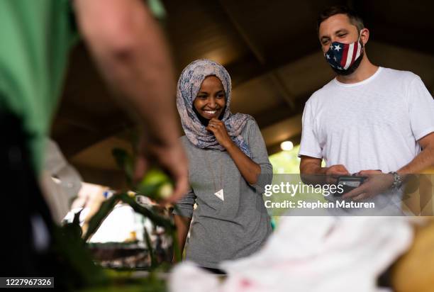 Rep. Ilhan Omar campaigns with her husband Tim Mynett at the Richfield Farmers Market on August 8, 2020 in Richfield, Minnesota. Omar is hoping to...