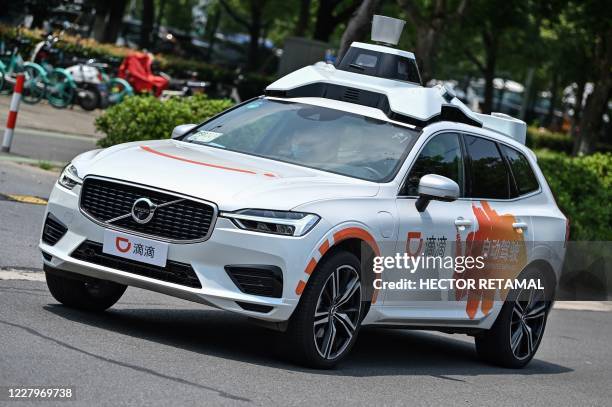 This photo taken on July 22, 2020 shows a Didi Chuxing autonomous taxi during a pilot test drive on the streets in Shanghai. - Chinese entrants in...