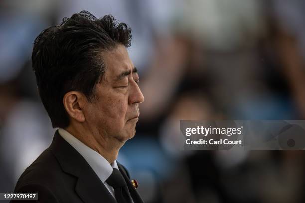 Japan's Prime Minister, Shinzo Abe, closes his eyes as he observes a moment of silence during the 75th anniversary of the Nagasaki atomic bombing, on...