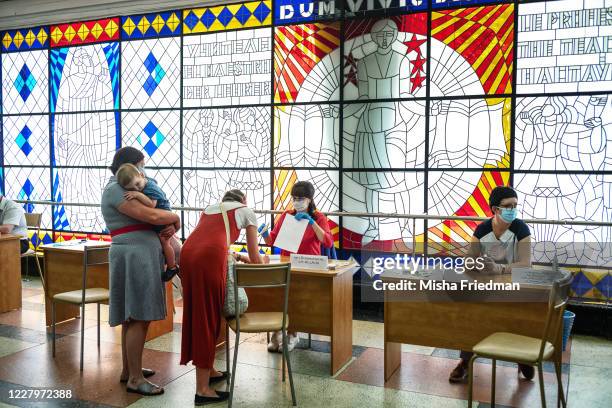 Woman gets ready to cast her ballot at a polling place in Minsk, Belarus on August 9, 2020. President Alexander Lukashenko is seeking to extend his...